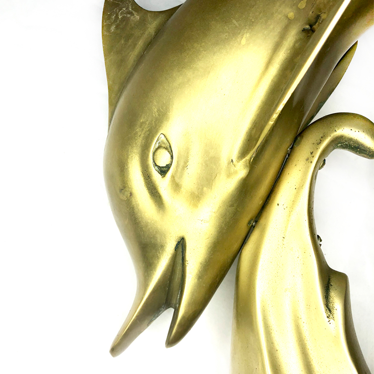 large brass dolphin statue